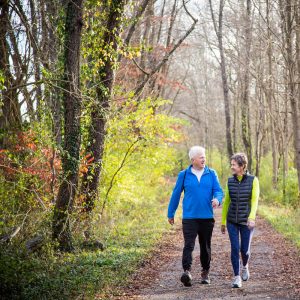 Couple walking down forest trail